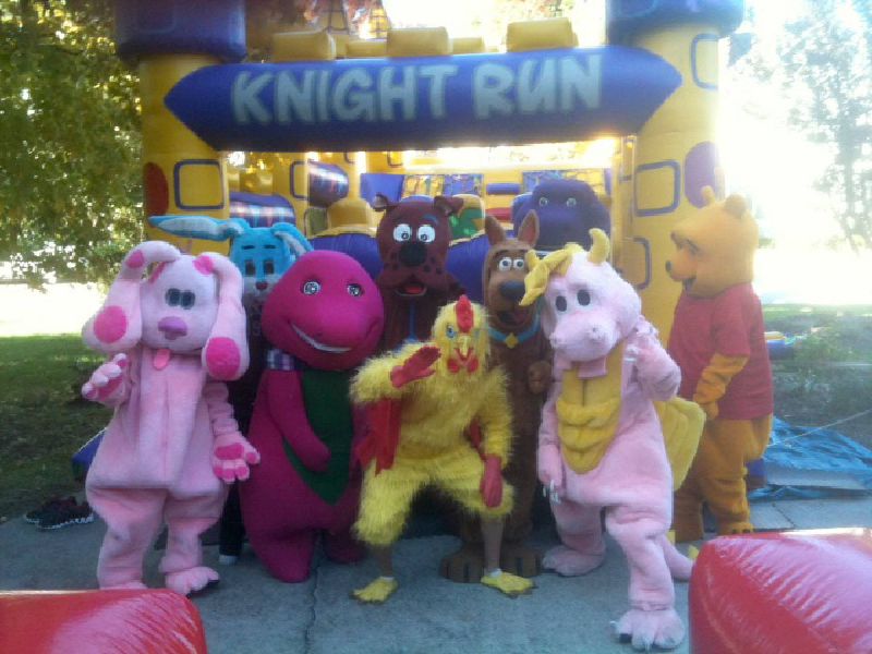 Costumed characters in front of obstacle course rental in Raleigh