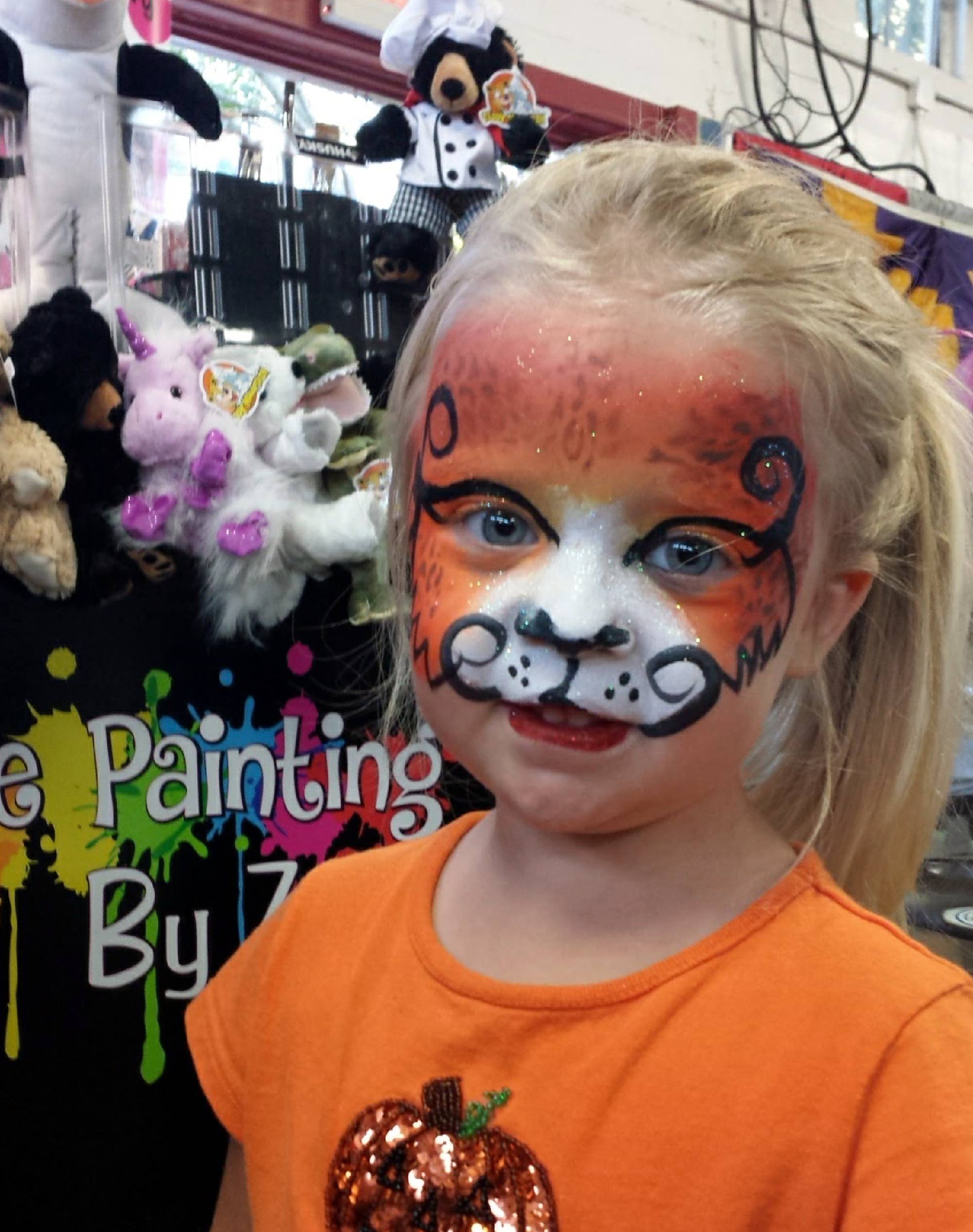 Face painting of orange cheetah girl from the NC State Fair