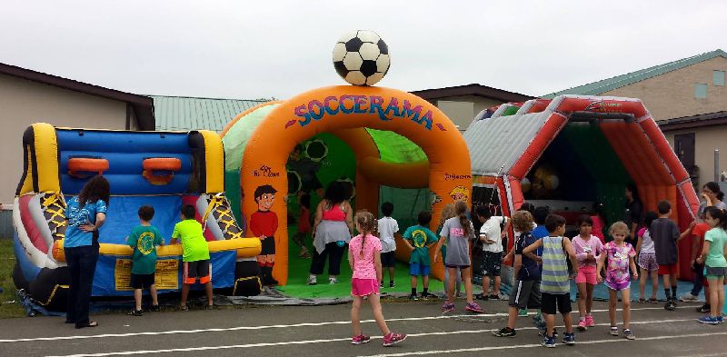 Wake county school kids having fun on the inflatable basketball, soccer, and alien invastion rental games on Field Day