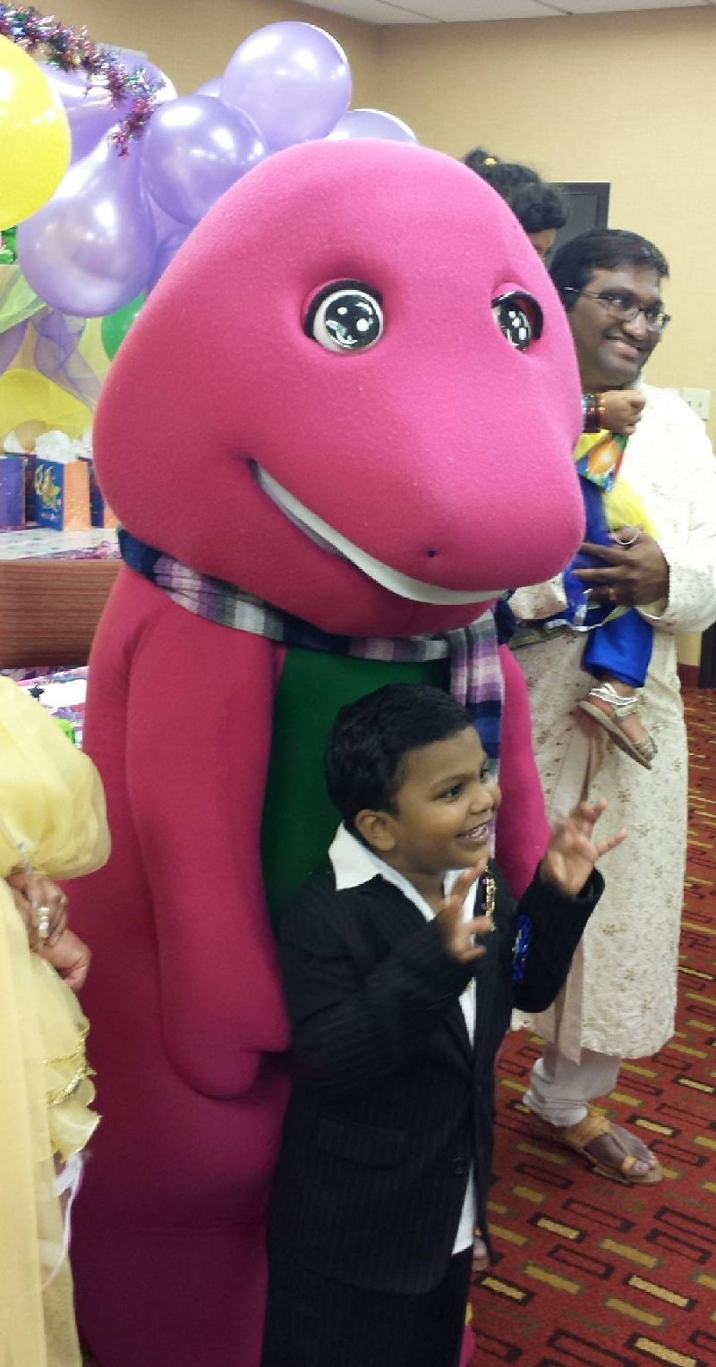 Purple dinosaur costumed character at birthday party in Cary