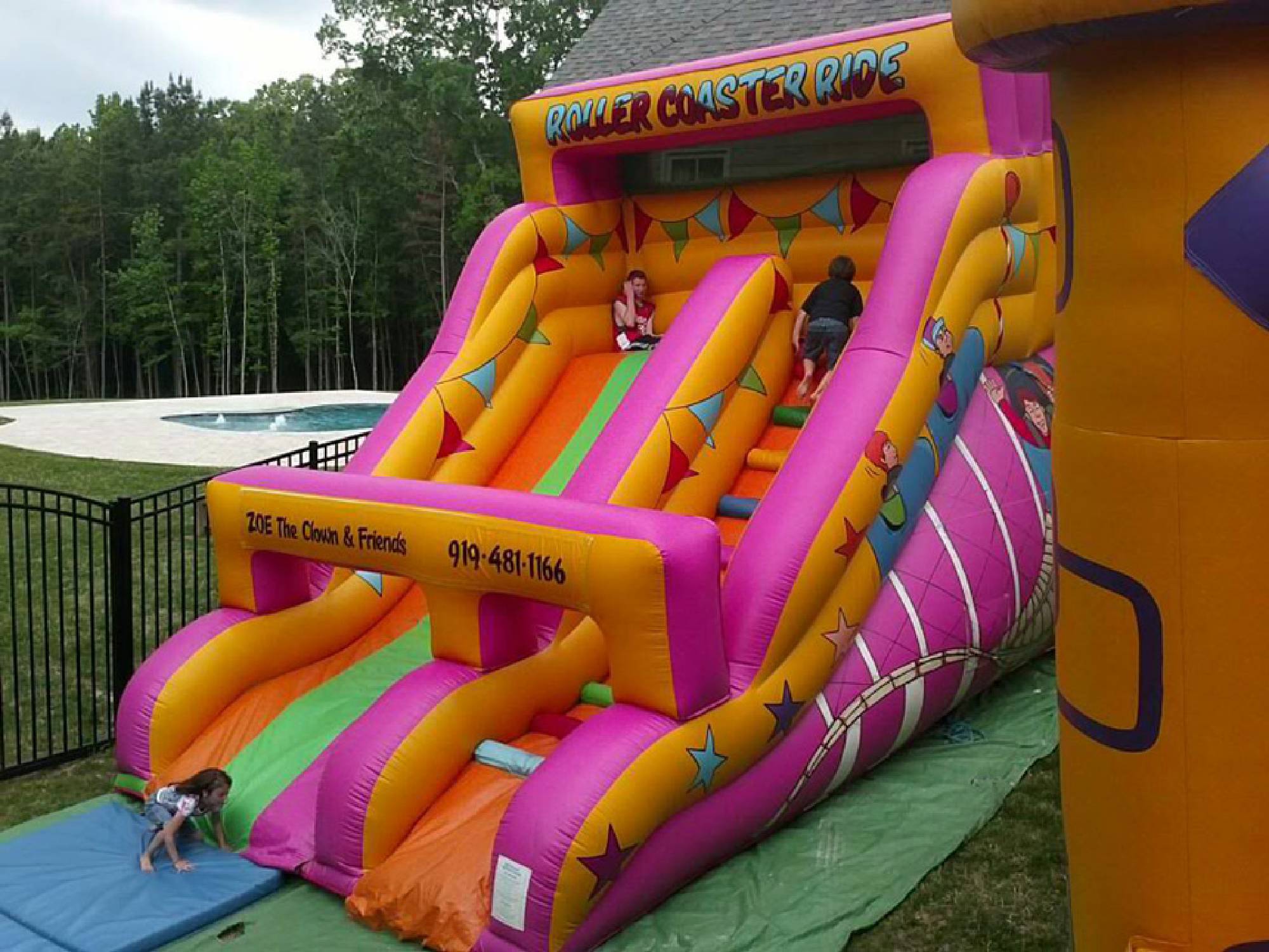 Roller coaster inflatable slide rental by a Raleigh pool